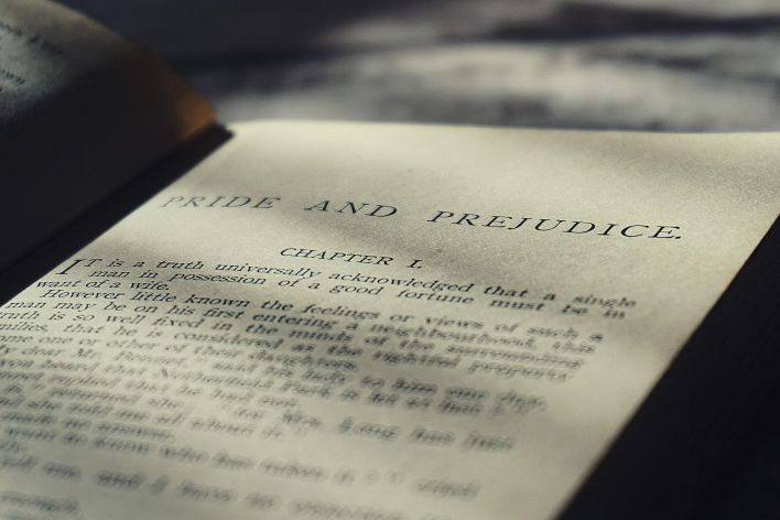 Close-up view of an open vintage page from Pride and Prejudice in warm sunlight.